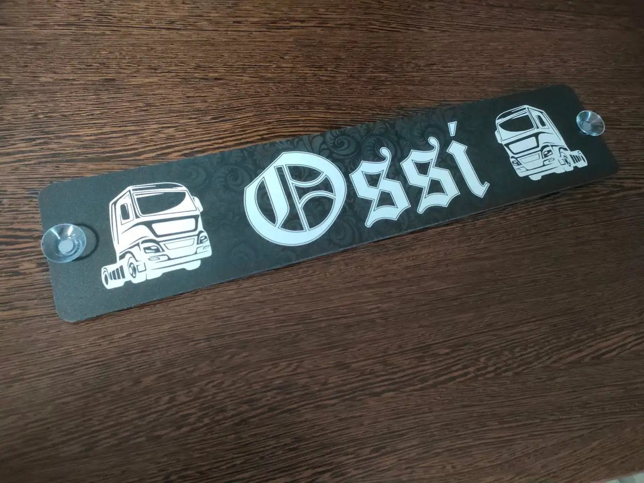 Personalized LKW license plate with suction cups, featuring truck designs and 'Ossi' text on a durable material.