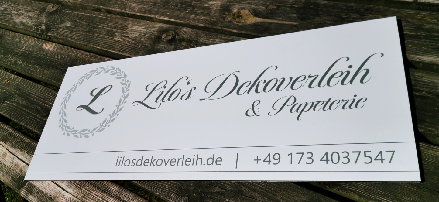 Outdoor company sign with elegant logo and contact details displayed on a wooden surface.