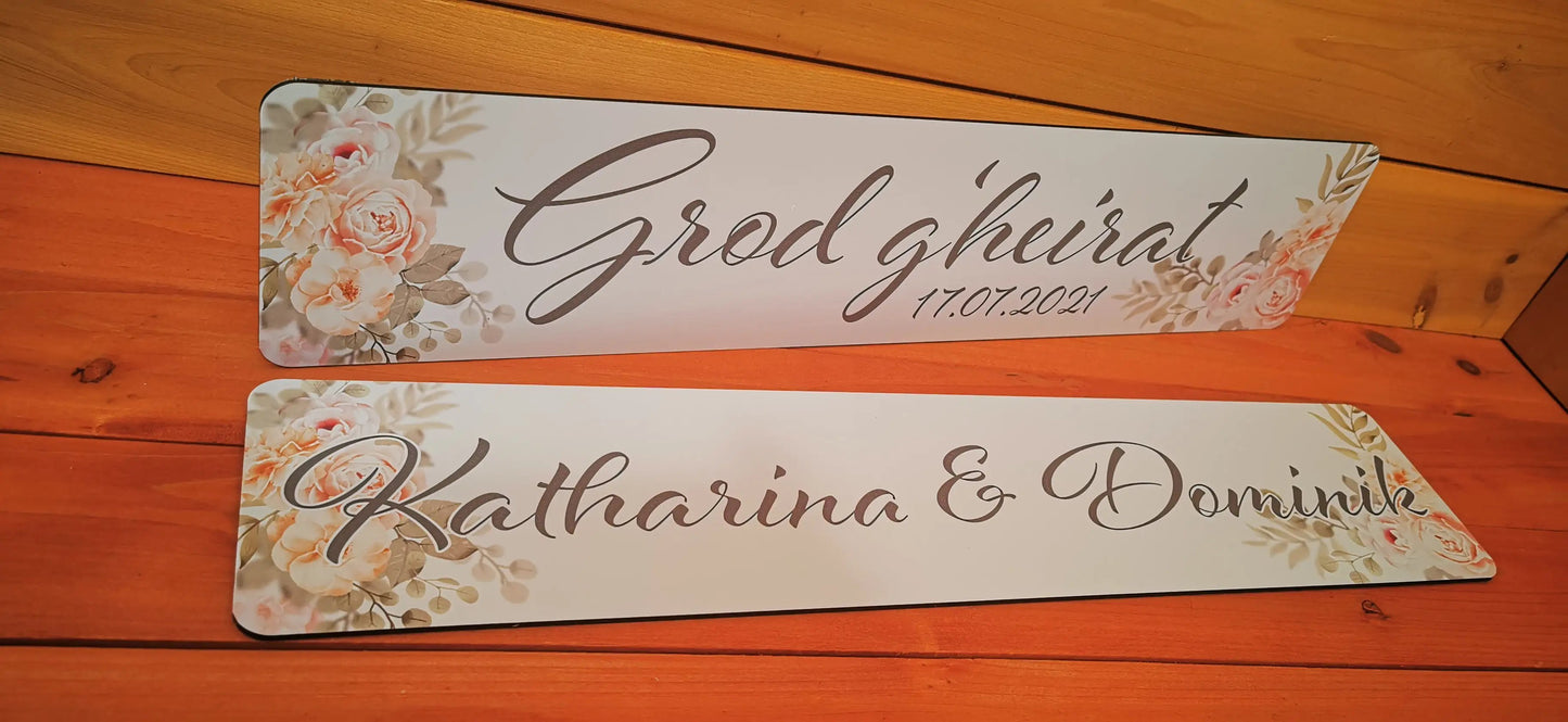 Elegantly designed wedding car license plates with floral accents and personalized text for a unique wedding decoration.