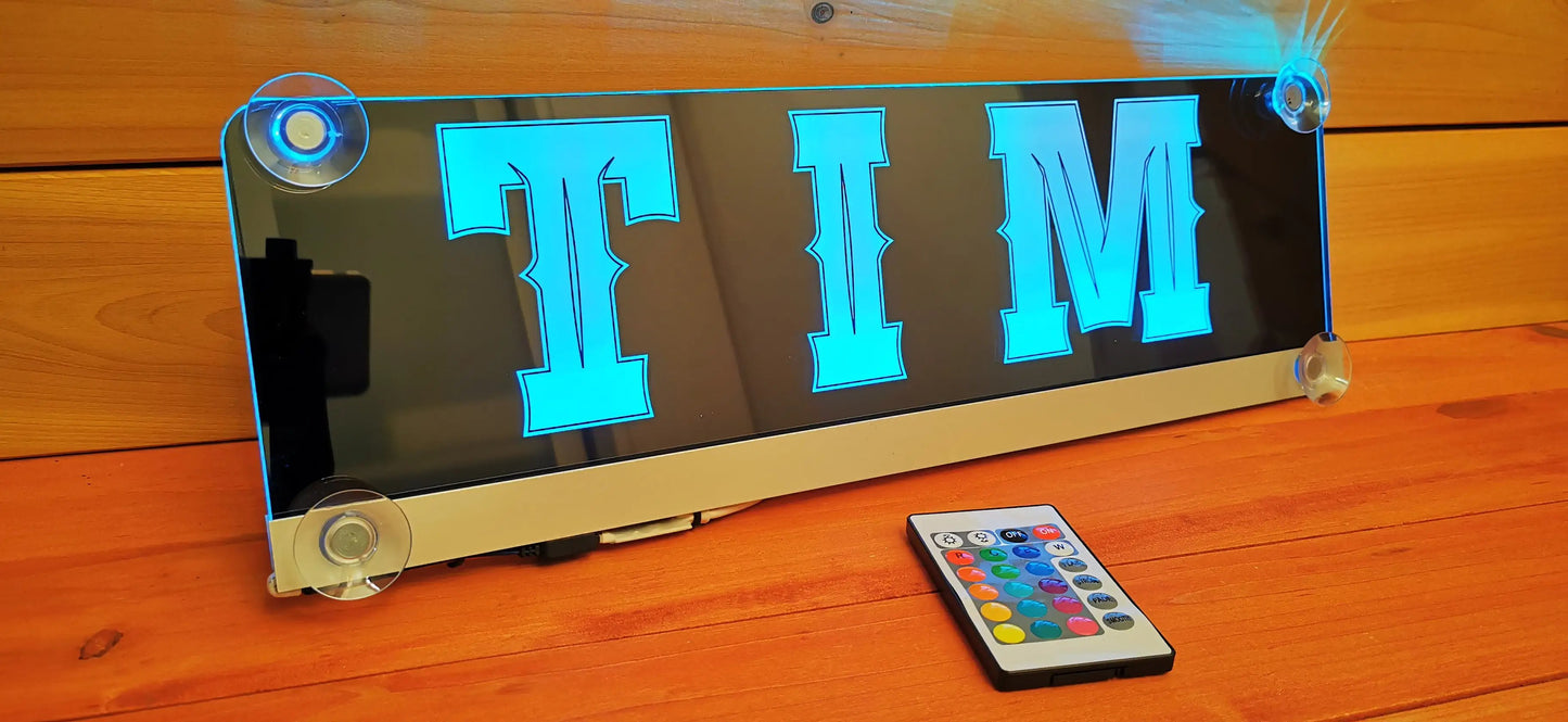 Illuminated LED truck nameplate 'TIM' with suction cups and remote control, ideal for personalized LKW cab decoration.