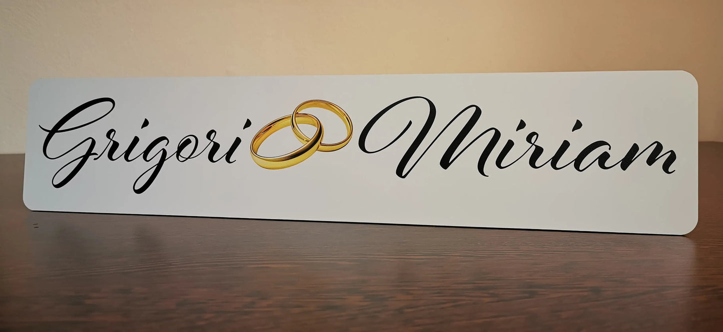 Wedding car license plate with elegant names design and golden rings symbol, personalized for a stylish wedding decoration.