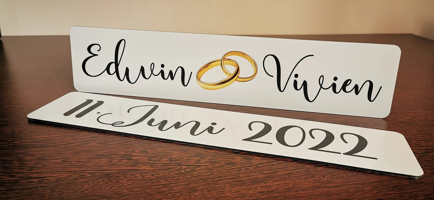 Custom wedding car license plates with names and wedding date, featuring elegant calligraphy and gold rings design, for memorable photos.