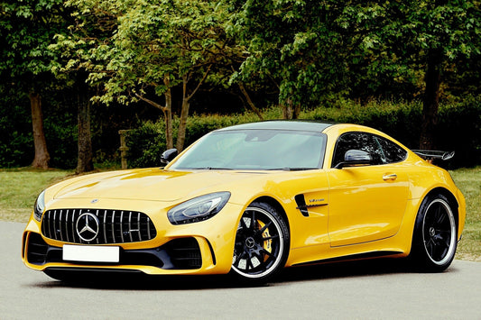 Yellow luxury sports car parked in a sunny outdoor setting, ideal for KFZ insurance comparison and savings.