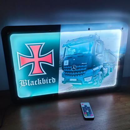 Illuminated LED sign with truck and cross emblem design, 50x30cm, USB powered with remote control for customizable lighting.