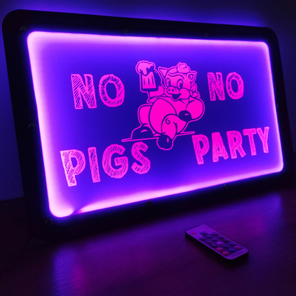 Illuminated LED sign with "No Pigs No Party" design in purple, featuring a remote control on a wooden surface.