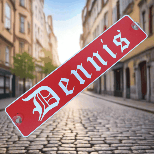B-Ware LKW-Namensschild 'Dennis' in red with gothic lettering, aluminum composite, suction cups attached, displayed on cobblestone street.