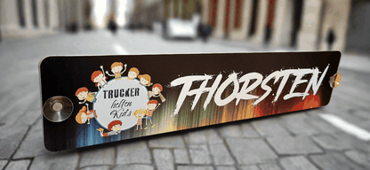 Custom LKW nameplate with "Thorsten" design printed on black alu-composite board, featuring colorful background and children motif.