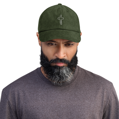 Man wearing a green cord cap with high-quality cross embroidery, stylish and durable, perfect fashion statement piece.