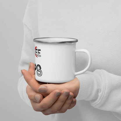 Person holding a white enamel mug with black and red lettering, showcasing the rustic design of the PRIPS Tos coffee or tea cup.