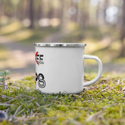 White enamel mug with 'PRIPS' lettering, resting on mossy ground in a forested background, ideal for outdoor coffee or tea drinking.