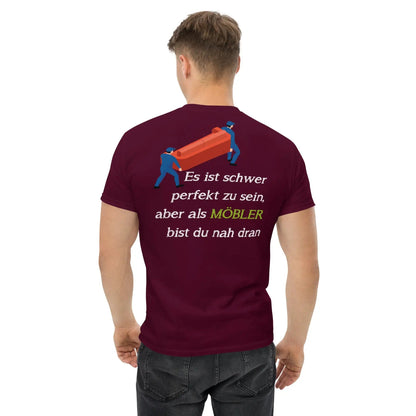 "Rückansicht eines Mannes im bordeauxfarbenen MÖBLER T-Shirt mit einem humorvollen Möbelumzugsprint."