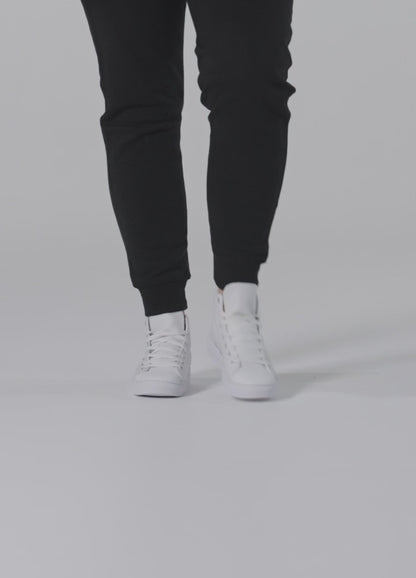 Woman wearing "Just married" high-top sneakers, showcasing stylish wedding footwear.