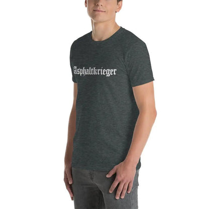 Model wearing a dark heather unisex T-shirt with 'Asphaltkrieger' print, showcasing stylish and durable fashion.