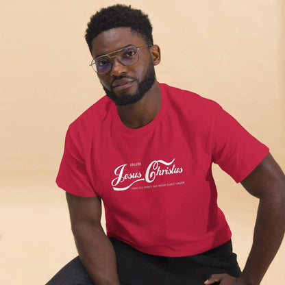 Man in red t-shirt with 'Erlebe Jesus Christus und du wirst nie mehr Durst haben' slogan, sitting against beige background