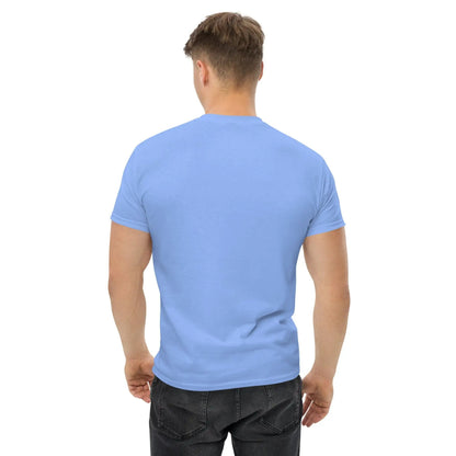 Back view of a man wearing a light blue T-shirt with a plain design, paired with black jeans.
