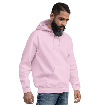 Man wearing a light pink hoodie with hands in pockets, facing sideways.