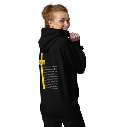 Woman wearing a black hoodie with a yellow cross and Psalm 23 design on the back, symbolizing comfort and inspirational message.