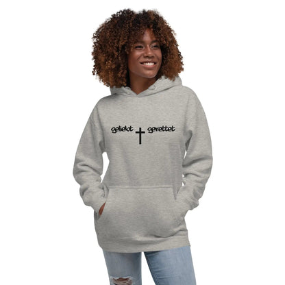 Woman wearing a gray hoodie with 'geliebt gerettet' and a cross design, featuring a kangaroo pocket, blending comfort and style.