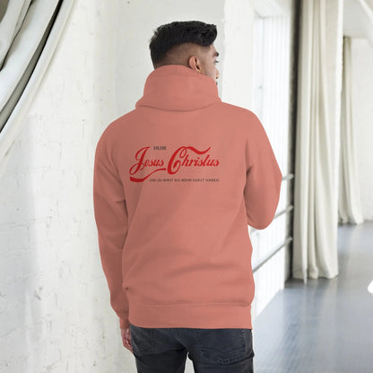 Person wearing a hoodie with 'Erlebe Jesus Christus und du wirst nie mehr Durst haben' printed on the back, inside a bright room.