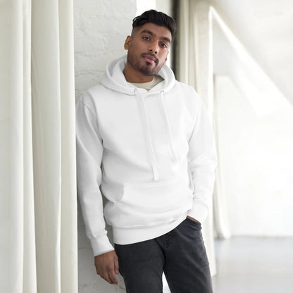 Person wearing a white hoodie while leaning against a white wall in a bright room.