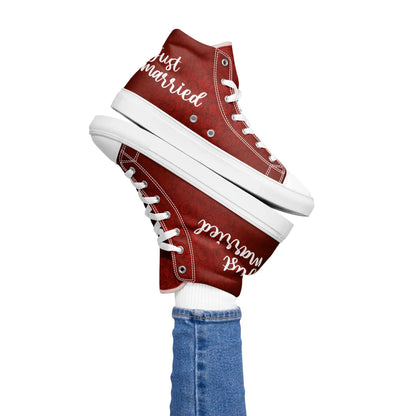 Red 'Just Married' sneakers for women with white lettering, styled on foot in jeans. Perfect for a chic wedding look.