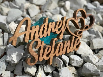 3D wooden family names on stones, personalized decor, made from durable hardwood, suitable for outdoor use, elegant design.