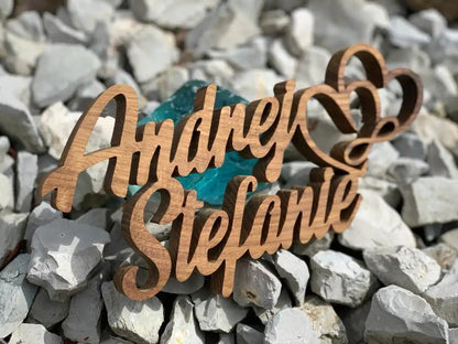 3D wooden family name sign with hearts, crafted from durable hardwood, suitable for outdoor display; personalized and elegant design.