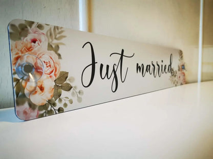 Luxury wedding car license plate with 'Just Married' text and floral design, perfect decor for wedding photos.
