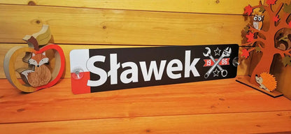 Custom LKW nametag displayed on a wooden table with decorative woodland ornaments, featuring a personalized design with tools and stars.