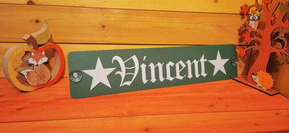 Personalized LKW nameplate with 'Vincent' text, mounted with suction cups on a wooden background, featuring decorative fox and owl figures.