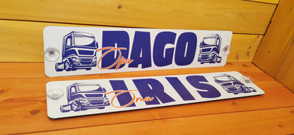 Custom LKW nameplates with suction cups featuring blue truck design on a wooden background.