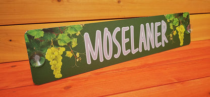 Custom LKW Namensschild with grapevine motif, featuring bold 'Moselaner' text, mounted with suction cups on a wooden background.