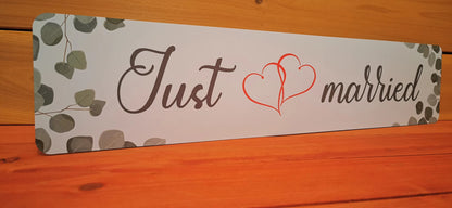 Elegant 'Just Married' wedding car plate with heart design, perfect for bridal celebrations and memorable photo shoots.