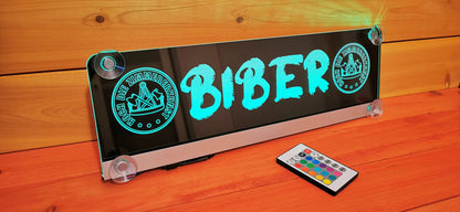 LED truck nameplate with "BIBER" text and remote control, featuring suction cup attachment for personalized design.