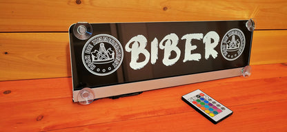 Illuminated LED truck name sign with suction cups and remote control, featuring custom design for personalized truck interiors.