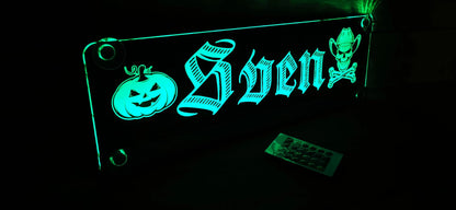 Illuminated LED truck nameplate with custom design featuring Halloween pumpkin and skull motifs.