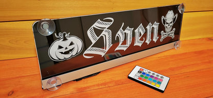 Illuminated LED truck nameplate with suction cups and remote control featuring a custom design for personalization.