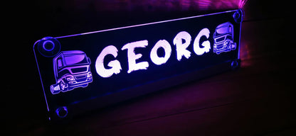 Illuminated LED truck nameplate with suction cups featuring the name 'GEORG' in bold letters and truck motifs, ideal for LKW interiors.