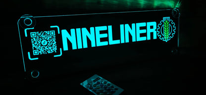 Illuminated LED nameplate for trucks with QR code and custom emblem in neon blue light.