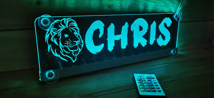 Illuminated LED truck name plate with suction cups and custom lion motif display.