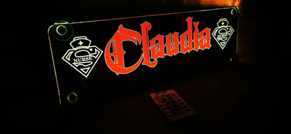 Illuminated LED nameplate for truck with "Claudia" and nurse motif, designed for personalization and night lighting.