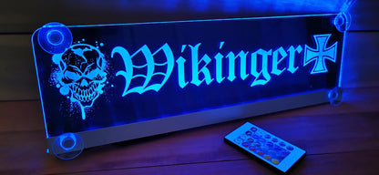 Illuminated LED nameplate for truck drivers with suction cups, featuring 'Wikinger' design and remote control on a wooden surface.