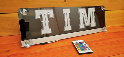 LED truck nameplate with "TIM" design, featuring suction cups and a remote control for color customization.