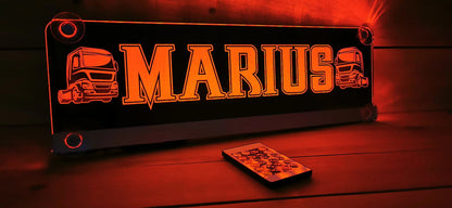 Illuminated LED truck nameplate with custom design and suction cups, displaying 'Marius' in bright orange letters.