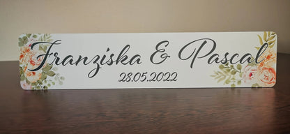 Personalized wedding license plate with floral design and names, perfect for bridal car decoration.