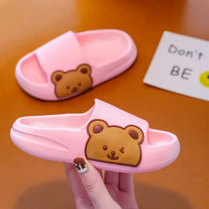 Pink children's slippers with cute bear design, featuring soft cushioning and lightweight for maximum comfort.