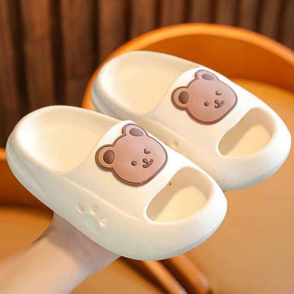 White children's slippers with teddy bear design, showcasing comfort and lightweight craftsmanship.