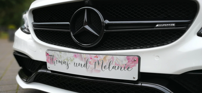 Custom wedding car license plate with floral design on a white luxury vehicle, ideal for personalized bridal car decoration.
